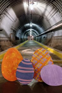 The Diefenbunker's Blast Tunnel with four large cut-out Easter eggs on the floor at the entrance to the tunnel.