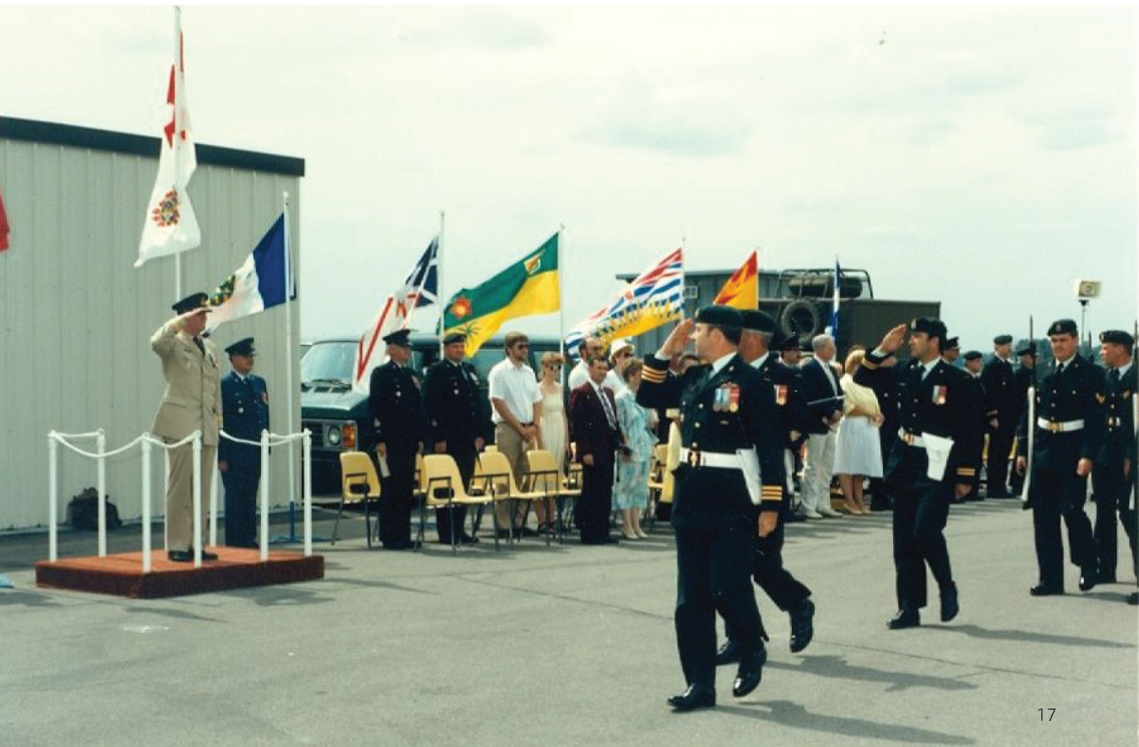 Photo from the Diefenbunker's 2018 Annual Report of members from CFS Carp walking outside while saluting each other.
