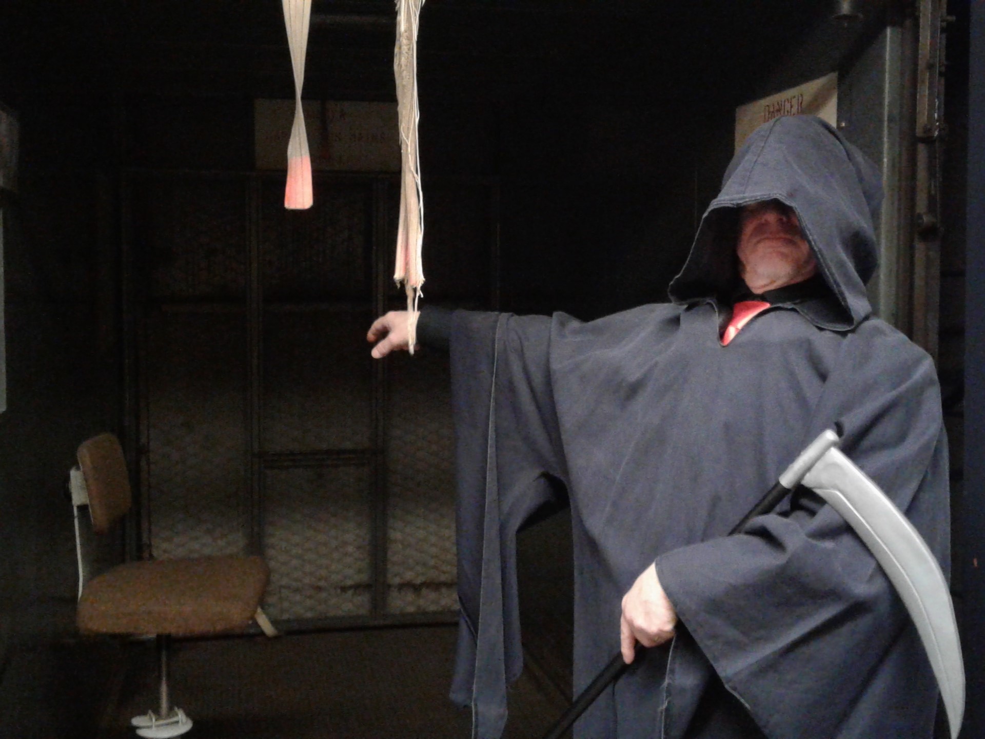 Past Diefenbunker employee dressed as the Grim Reaper stands in front of the freight elevator during a holiday party.