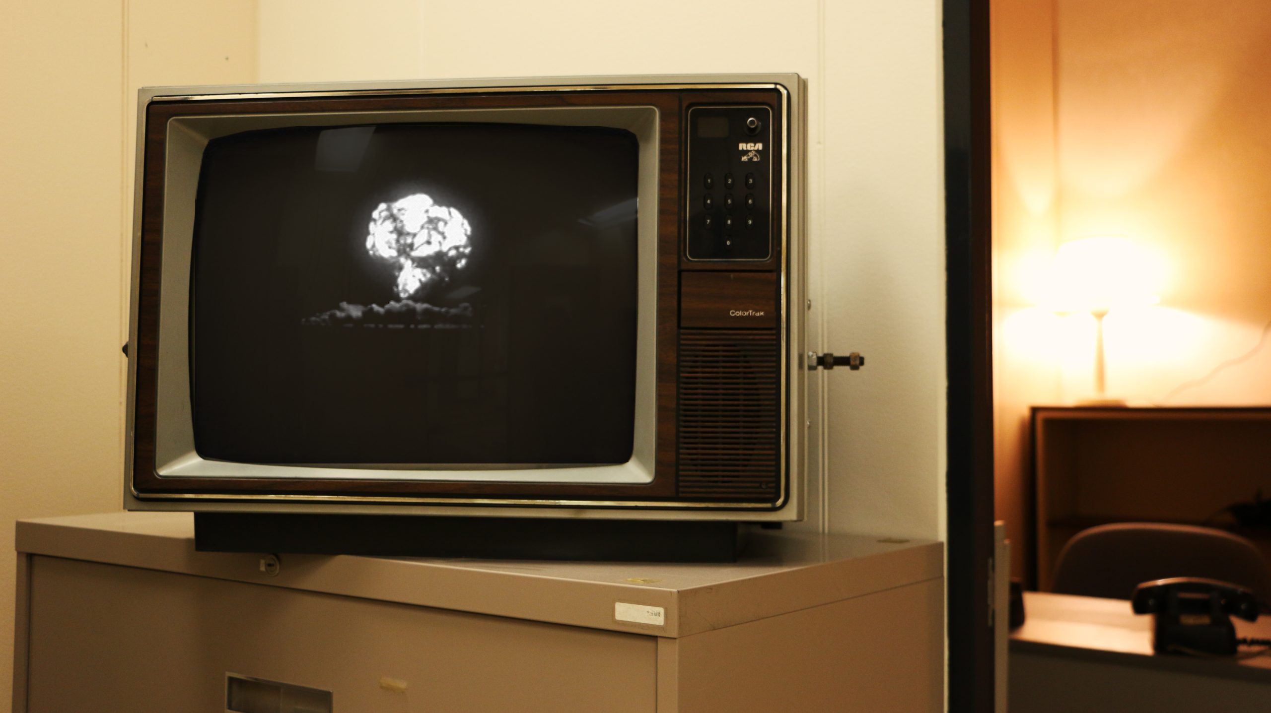Old television displays video of nuclear bomb.