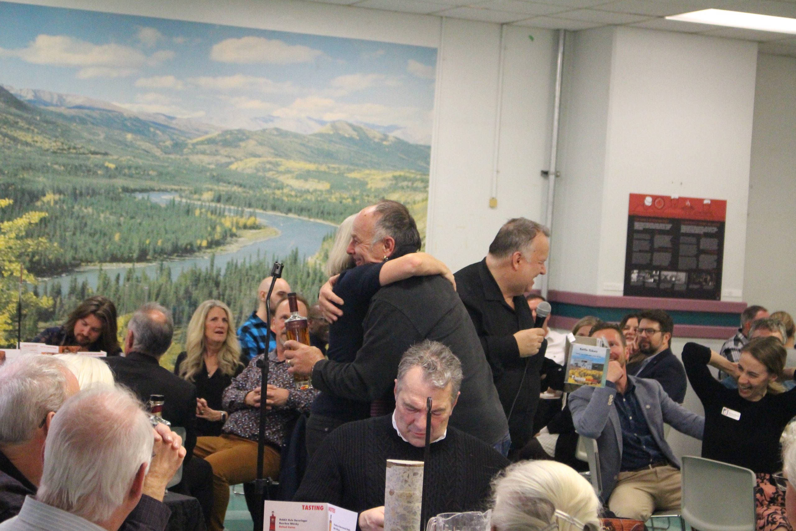 Guests hug at the Diefenbunker's signature annual Whisky Tasting Fundraiser. 
