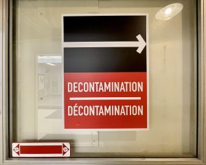"Decontamination" sign pointing to a series of showers on the inside of the Diefenbunker's blast doors. 