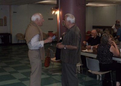 Two Diefenbunker Alumni having a discussion in the Cafeteria.