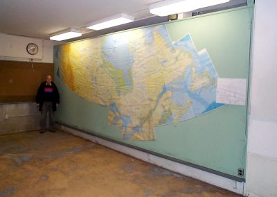 Diefenbunker Alumni standing next to map