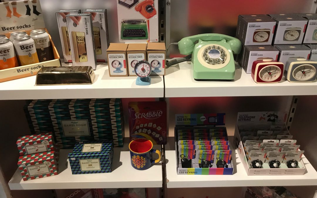 Rotary phone and other retro items located on three shelves in the Gift Shop.