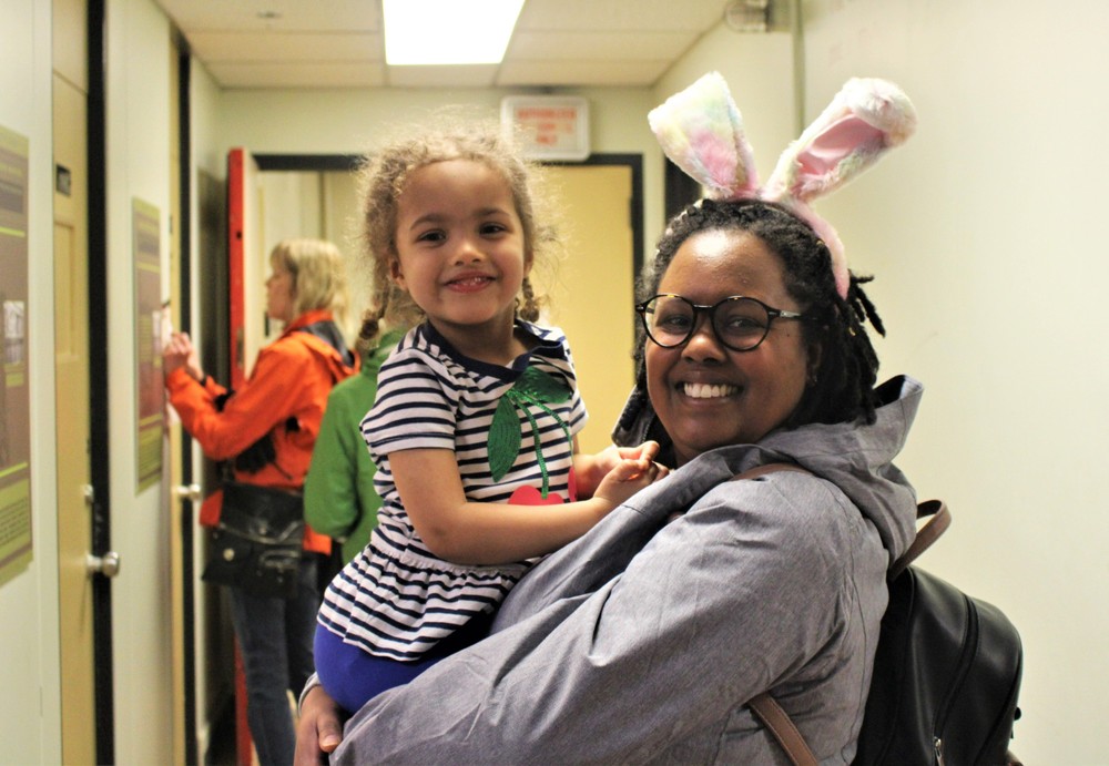 Family smiling and one individual is wearing bunny ears while at the Diefenbunker's Easter event.