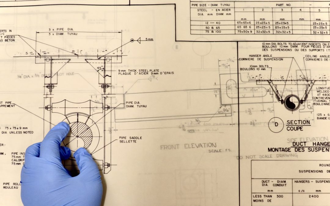 Diefenbunker blueprint with a hand wearing a glove.