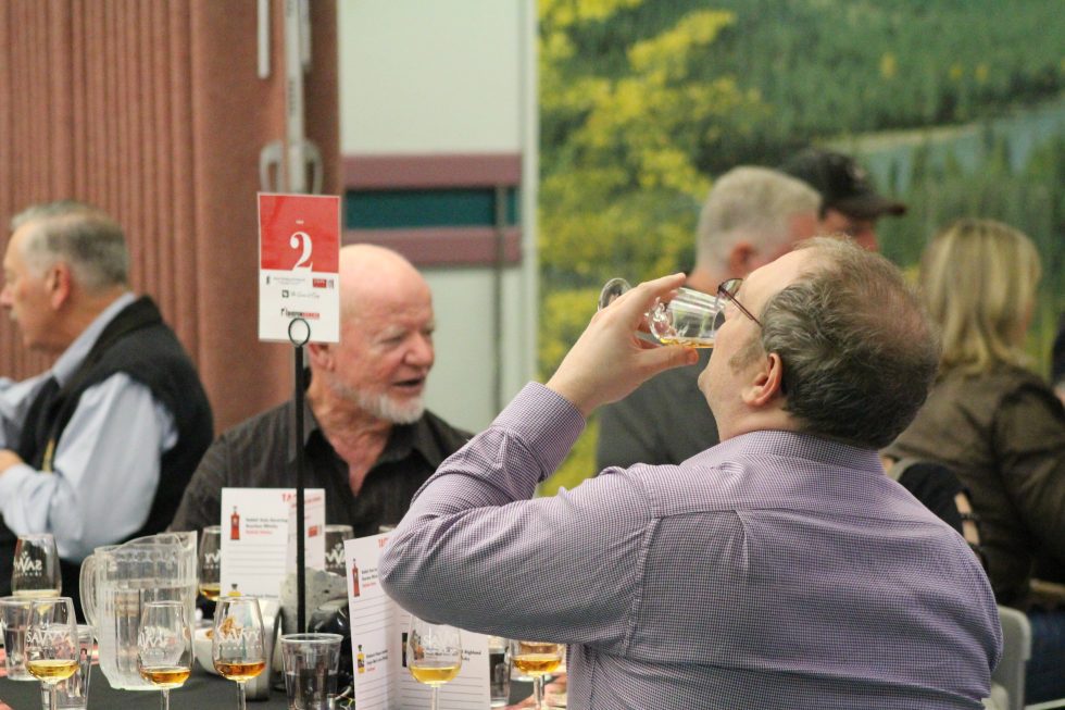 Person drinks from a whisky glass at the Diefenbunker's annual Whisky Tasting Fundraiser.