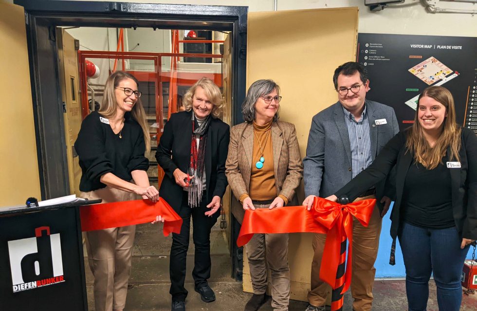 1: Ribbon-cutting ceremony to open an accessible public viewing platform in the Diefenbunker’s historic Machine Room, one of the museum’s newest initiatives funded by the Ontario Trillium Foundation. Pictured left to right: Christine McGuire, Diefenbunker Executive Director; Karen McCrimmon, MPP for Kanata—Carleton; Mary Mercer, Ontario Trillium Foundation volunteer; Sean Campbell, Diefenbunker Curator; Tobie Champion-Demers, Diefenbunker Facilities and Project Manager. Image courtesy of the Diefenbunker: Canada’s Cold War Museum.