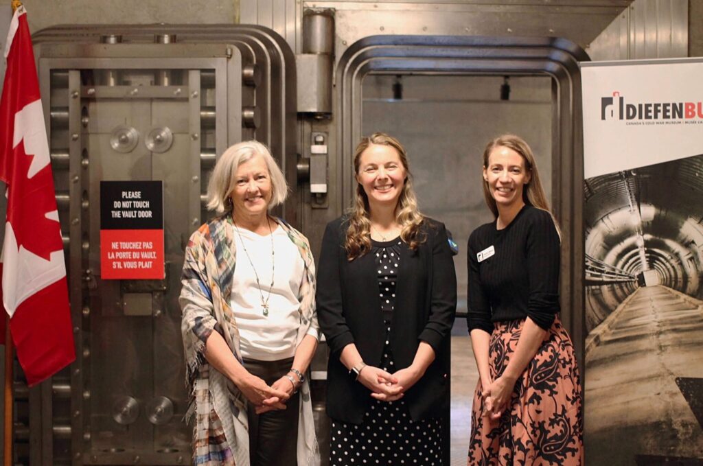 Announcement of the Diefenbunker as a recipient of federal government funding through the Green and Inclusive Community Buildings (GICB) program. Pictured left to right: Susan McLeod, Chair, Diefenbunker Board of Directors; the Honourable Jenna Sudds, Minister of Families, Children and Social Development; Christine McGuire, Diefenbunker Executive Director. Image courtesy of the Diefenbunker: Canada’s Cold War Museum.