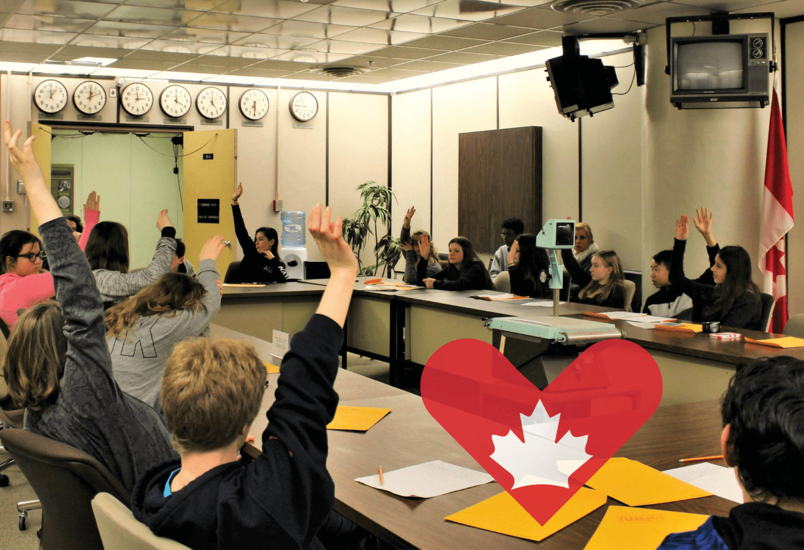 Students raise their hands as they participate in an educational program in the War Cabinet Room at the Diefenbunker.