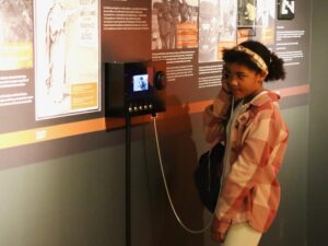 A child holds an interactive listening device in an exhibition at the Diefenbunker Museum.