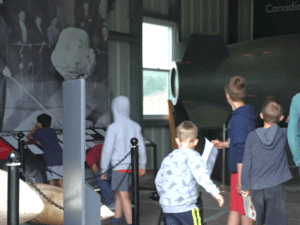 A group of young children excitedly dash into the museum entrance at the Diefenbunker.