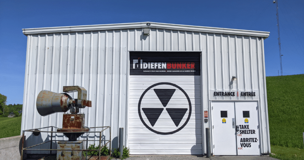 Exterior of a Difleen Lumber building with a large garage door featuring a radiation symbol.