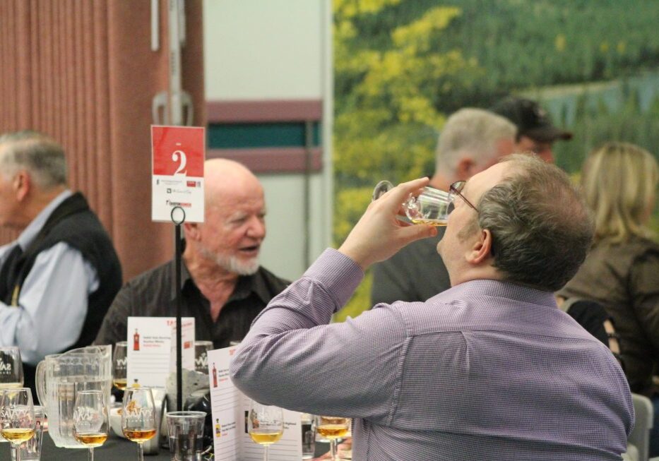 Person drinks from a whisky glass at the Diefenbunker's annual Whisky Tasting Fundraiser.