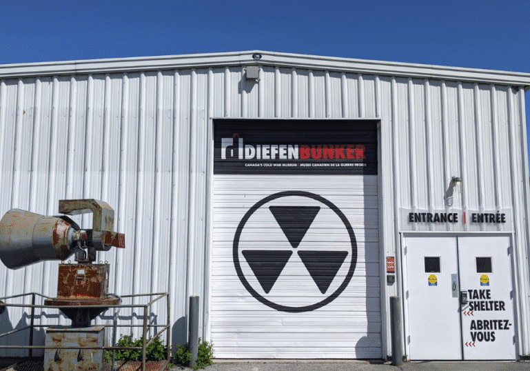 Exterior of a Difleen Lumber building with a large garage door featuring a radiation symbol.