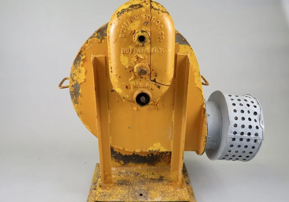 A yellow fire hydrant with rust on it.